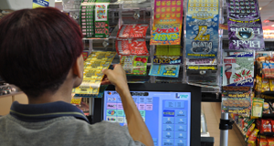 Customer selects a scratch off game from the rack of available options