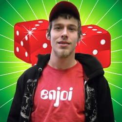 Man in a red tshirt poses in front of green digital background with red dice on it
