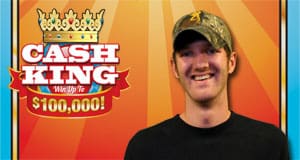 Man in a camo hat poses in front of an orange sun ray background beside the Cash King logo