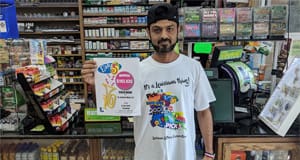 Man holds up an Easy 5 winner sign in front of a retail counter