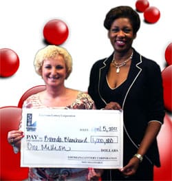 Two women hold an oversized check in front of a white background with red Powerballs