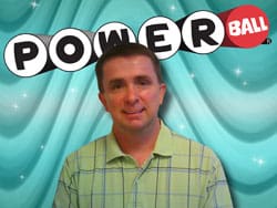 Man in a green collared shirt smiles in front of a blue digital background with the Powerball logo