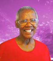 Woman in glasses and a red shirt smiles in front of a purple digital background