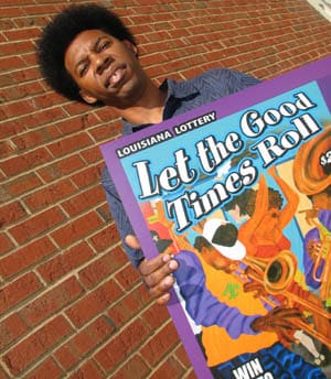 Shot from below, a man stands in front of a brick wall and holds a giant poster depicting musicians and dancers with the text 