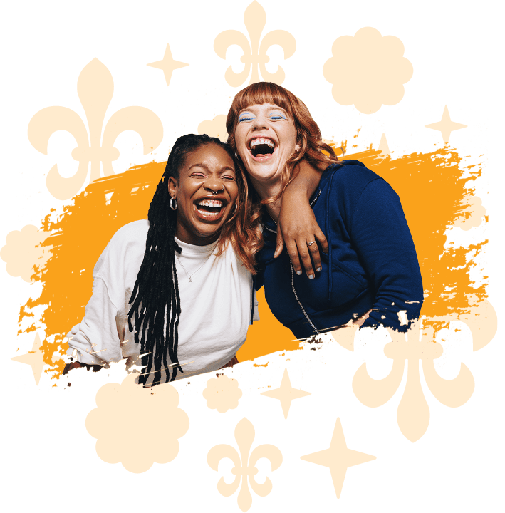 Two women laughing together with their eyes closed and their arms around each other on a yellow scribble background