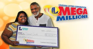 Man and woman hold oversized check in front of a yellow Mega Millions branded background