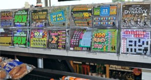 Clear rack of available scratch off ticket options on a retail counter