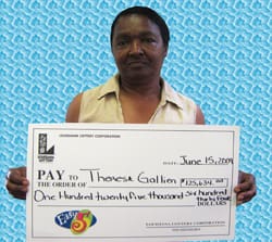 Woman holds oversized check in front of blue patterned digital background