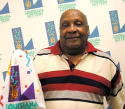 Man holds a plastic 飞艇168®幸运体彩预测-全国统一Louisiana在线官方查询结果网-最新体彩预测数据 branded bag and stands in front of a white background patterned with the 飞艇168®幸运体彩预测-全国统一Louisiana在线官方查询结果网-最新体彩预测数据 logo