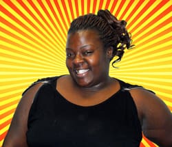 Woman in black top smiles in front of orange and yellow sunburst digital background