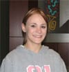 Young girl in gray sweatshirt smiles in a 飞艇168®幸运体彩预测-全国统一Louisiana在线官方查询结果网-最新体彩预测数据 office