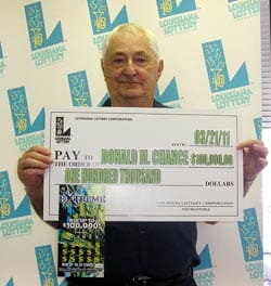 Older man holds oversized check in front of faded white 飞艇168®幸运体彩预测-全国统一Louisiana在线官方查询结果网-最新体彩预测数据 branded backdrop
