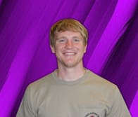 Young man in a gray tshirt smiles in front of a purple textured digital background